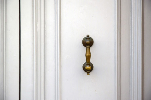 brass handle on a white door