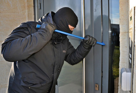 Burglar breaking a door
