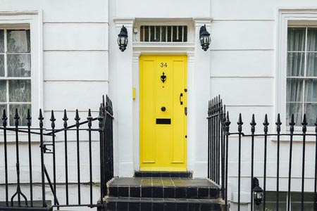 Yellow entry door with matte black front door handle set