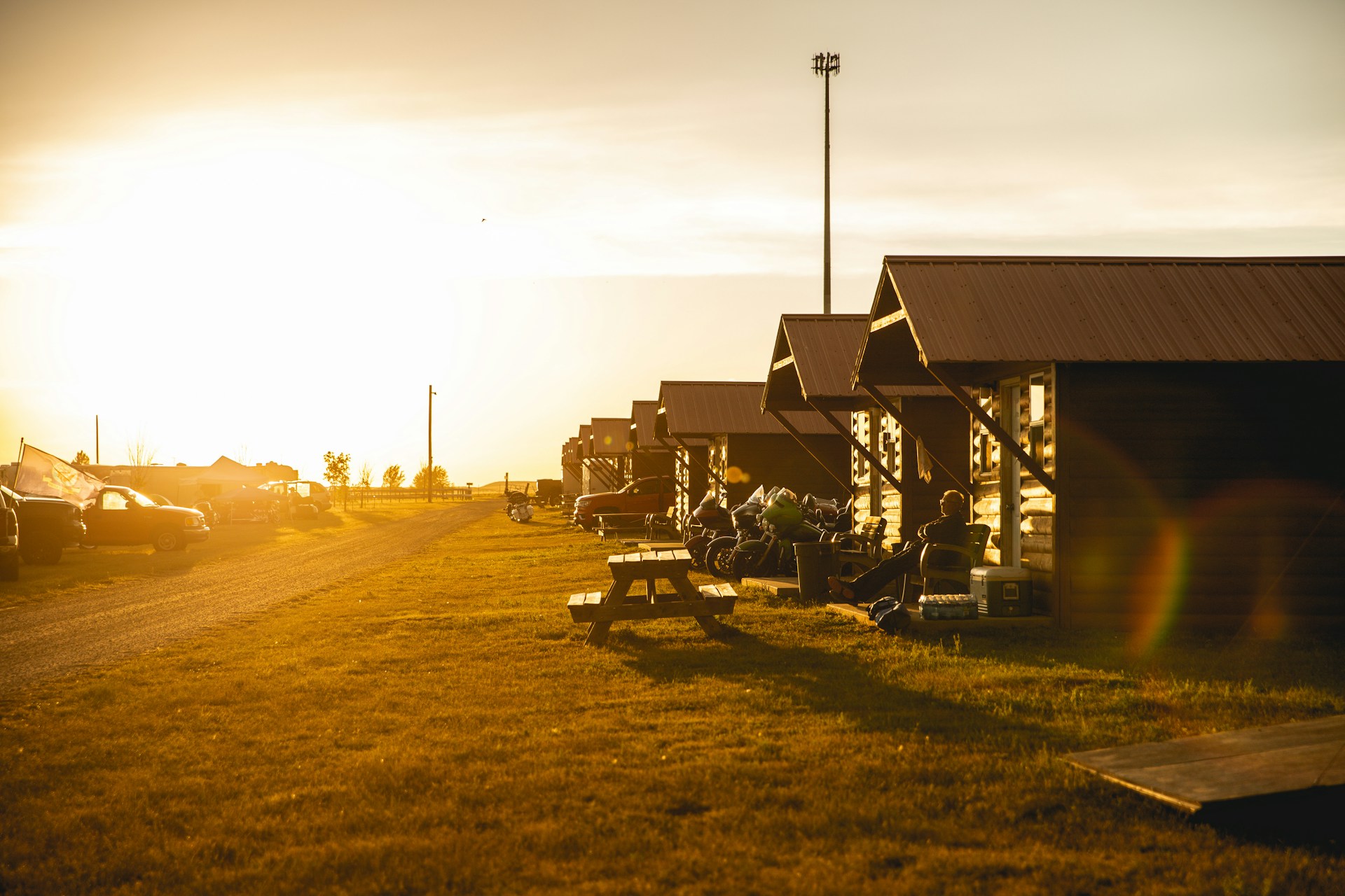 Row of summer camp cabins at sunset